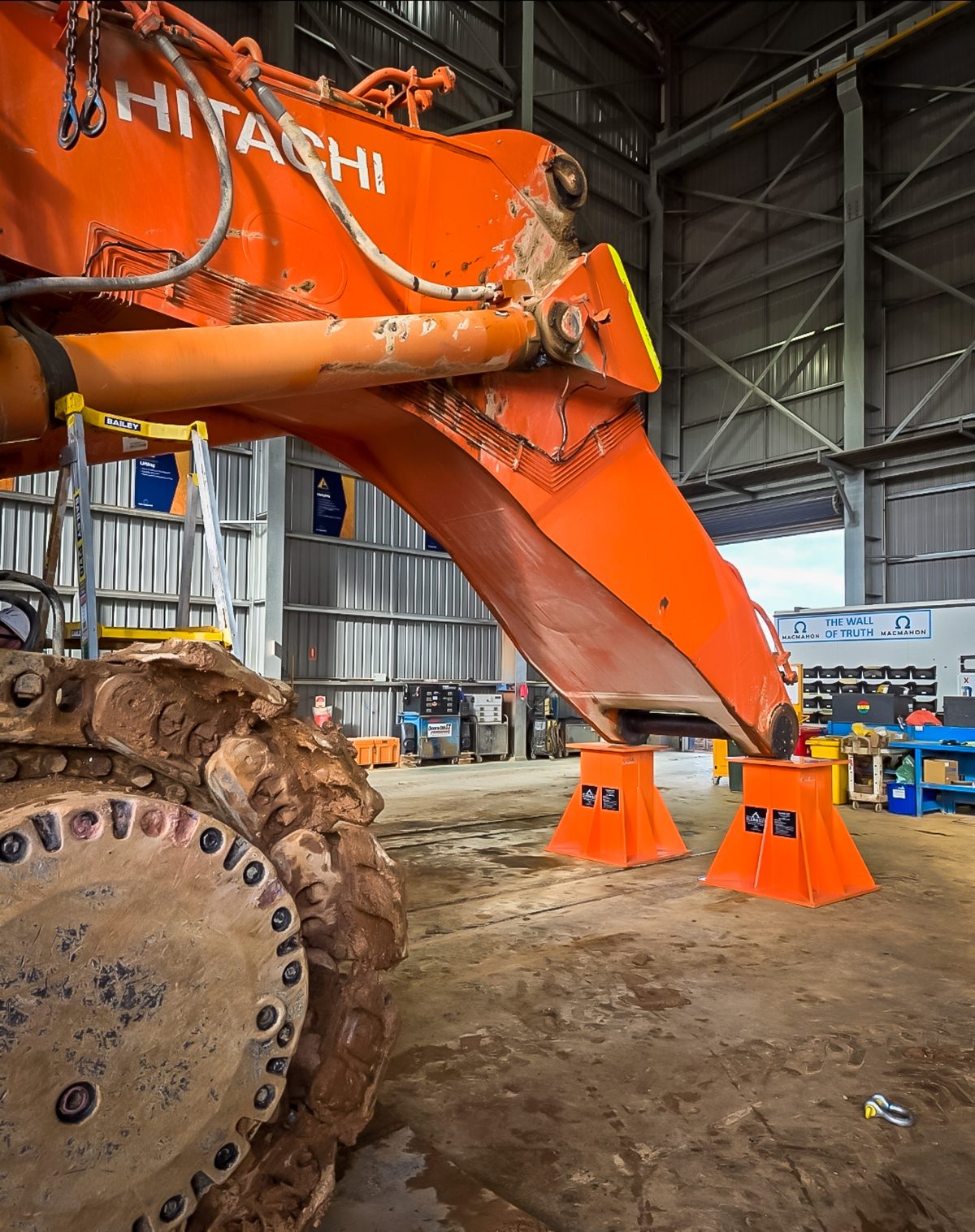 Hitachi excavator boom in the workshop on stands